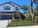 Two-story modern home with brick accents and a gray garage door at 1046 Bass Blvd, Dunedin, FL 34698