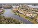 Aerial view of community with lakefront homes and lush landscaping at 10553 Bermuda Isle Dr, Tampa, FL 33647