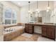 Bathroom boasts double vanity, soaking tub and glass block shower at 10553 Bermuda Isle Dr, Tampa, FL 33647