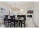 Formal dining room with chandelier and view of kitchen at 10553 Bermuda Isle Dr, Tampa, FL 33647