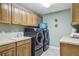 Laundry room with washer, dryer, and built-in cabinets at 10553 Bermuda Isle Dr, Tampa, FL 33647