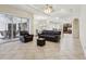 Spacious living room with leather furniture and access to patio at 10553 Bermuda Isle Dr, Tampa, FL 33647