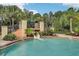 Water slide and pool area with palm trees and lush landscaping at 10553 Bermuda Isle Dr, Tampa, FL 33647