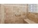 Walk-in shower with tiled walls and built-in seat at 10553 Bermuda Isle Dr, Tampa, FL 33647