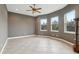 Sunroom with tile floors, windows, and ceiling fan at 10553 Bermuda Isle Dr, Tampa, FL 33647