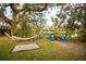 Serene backyard oasis with hammock and fire pit at 10745 Bardes Ct, Seminole, FL 33777