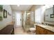 Bathroom with walk-in shower, granite vanity, and wood cabinets at 10745 Bardes Ct, Seminole, FL 33777