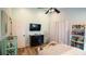 Bedroom with black dresser, white curtains, and a TV at 10745 Bardes Ct, Seminole, FL 33777