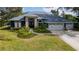 Beautiful two-story home with a three-car garage and landscaped yard at 10745 Bardes Ct, Seminole, FL 33777