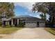 Spacious home with a three-car garage and mature trees at 10745 Bardes Ct, Seminole, FL 33777