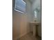 Clean and simple pedestal sink bathroom with mirror at 10812 Fanning Springs Ct, Tampa, FL 33647