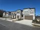 Row of townhomes with gray exteriors and brown garage doors at 10812 Fanning Springs Ct, Tampa, FL 33647