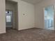 Bright hallway with carpet flooring and laundry access at 10812 Fanning Springs Ct, Tampa, FL 33647