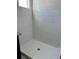 Clean shower with white tile and large shower head at 10812 Fanning Springs Ct, Tampa, FL 33647