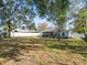 Large backyard with a screened patio and mature trees at 11013 Cranston St, Spring Hill, FL 34608