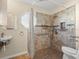 Accessible bathroom with roll-in shower, grab bars, and tiled walls at 11013 Cranston St, Spring Hill, FL 34608