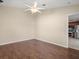 Bright bedroom with wood-look flooring and access to kitchen at 11013 Cranston St, Spring Hill, FL 34608