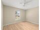 Bright bedroom with light wood flooring and a ceiling fan at 11013 Cranston St, Spring Hill, FL 34608