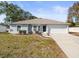 Single-story home with attached garage and well-manicured lawn at 11013 Cranston St, Spring Hill, FL 34608