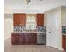 Kitchen boasts granite counters and a tile backsplash at 11013 Cranston St, Spring Hill, FL 34608