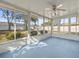 Bright sunroom with light blue flooring and ceiling fan at 11013 Cranston St, Spring Hill, FL 34608