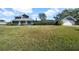 Large backyard with a screened enclosure and detached garage at 11201 Lake Sassa Dr, Thonotosassa, FL 33592