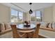 Bright breakfast nook with window seating and a rustic wooden table at 11201 Lake Sassa Dr, Thonotosassa, FL 33592