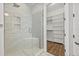 Modern bathroom with a glass-enclosed shower, built-in bench, and ample closet space at 11220 Moultrie Pl, Tampa, FL 33625