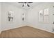 Spacious bedroom with hardwood floors, plantation shutters, and ceiling fan at 11220 Moultrie Pl, Tampa, FL 33625