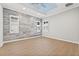 Bedroom with wood-look walls and light hardwood floors at 11220 Moultrie Pl, Tampa, FL 33625