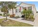 White house with gray shutters, palm trees, and walkway at 11220 Moultrie Pl, Tampa, FL 33625