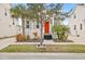 Single-story house with orange door and gray shutters at 11220 Moultrie Pl, Tampa, FL 33625