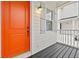 Front porch with orange door and gray siding at 11220 Moultrie Pl, Tampa, FL 33625