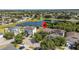 Aerial view of a home near a pond in a neighborhood with lots of trees at 11540 Balintore Dr, Riverview, FL 33579