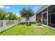 Fenced in backyard with a playset and green lawn at 11540 Balintore Dr, Riverview, FL 33579