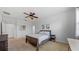 Cozy bedroom featuring a queen-size bed, carpet floors, and a ceiling fan at 11540 Balintore Dr, Riverview, FL 33579