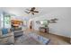 Open-concept living room with tile floors and ceiling fan, adjacent to the modern kitchen at 11540 Balintore Dr, Riverview, FL 33579