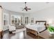 Main bedroom with sitting area and large windows at 11919 Royce Waterford Cir, Tampa, FL 33626