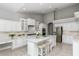 Bright kitchen featuring white cabinets, a center island, and stainless steel appliances at 11919 Royce Waterford Cir, Tampa, FL 33626