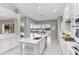 Modern kitchen with white cabinetry and large island at 11919 Royce Waterford Cir, Tampa, FL 33626