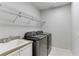 Laundry room with washer, dryer, and utility sink at 11919 Royce Waterford Cir, Tampa, FL 33626