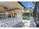 Outdoor kitchen and screened-in pool with patio area at 11919 Royce Waterford Cir, Tampa, FL 33626