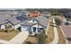 Aerial view of a light blue house with a gray roof in a neighborhood at 12119 Creek Preserve Dr, Riverview, FL 33579