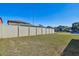 A backyard with a white vinyl fence and grass at 12119 Creek Preserve Dr, Riverview, FL 33579