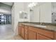 Bathroom with granite countertop, wood cabinets, and mirror at 12119 Creek Preserve Dr, Riverview, FL 33579