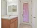 Bathroom with wood vanity, mirror and door to outside at 12119 Creek Preserve Dr, Riverview, FL 33579