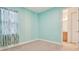 Light teal bedroom with patterned curtains and carpet at 12119 Creek Preserve Dr, Riverview, FL 33579