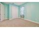 Bedroom with light teal walls, carpet and double doors at 12119 Creek Preserve Dr, Riverview, FL 33579