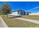 Single-story home with light blue exterior, partial view of backyard, and sidewalk at 12119 Creek Preserve Dr, Riverview, FL 33579