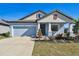 Newly built home with light blue exterior, landscaping, and a two-car garage at 12119 Creek Preserve Dr, Riverview, FL 33579